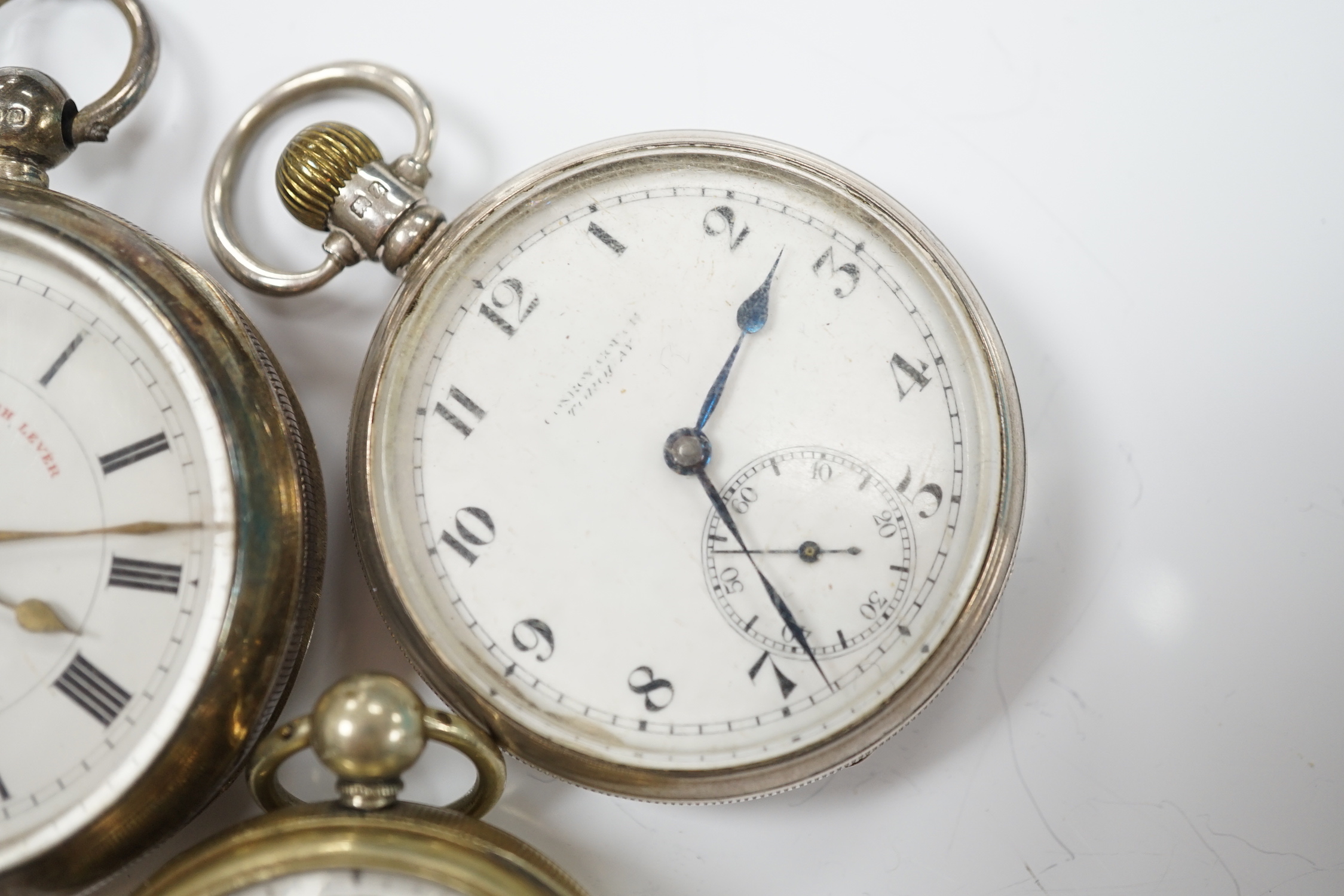 A Georgian gilt metal pair cased pocket watch (lacking outer case) by Masters of Piccadilly, with Roman dial, together with two early 20th century silver open face pocket watches including 'Express English Lever'.